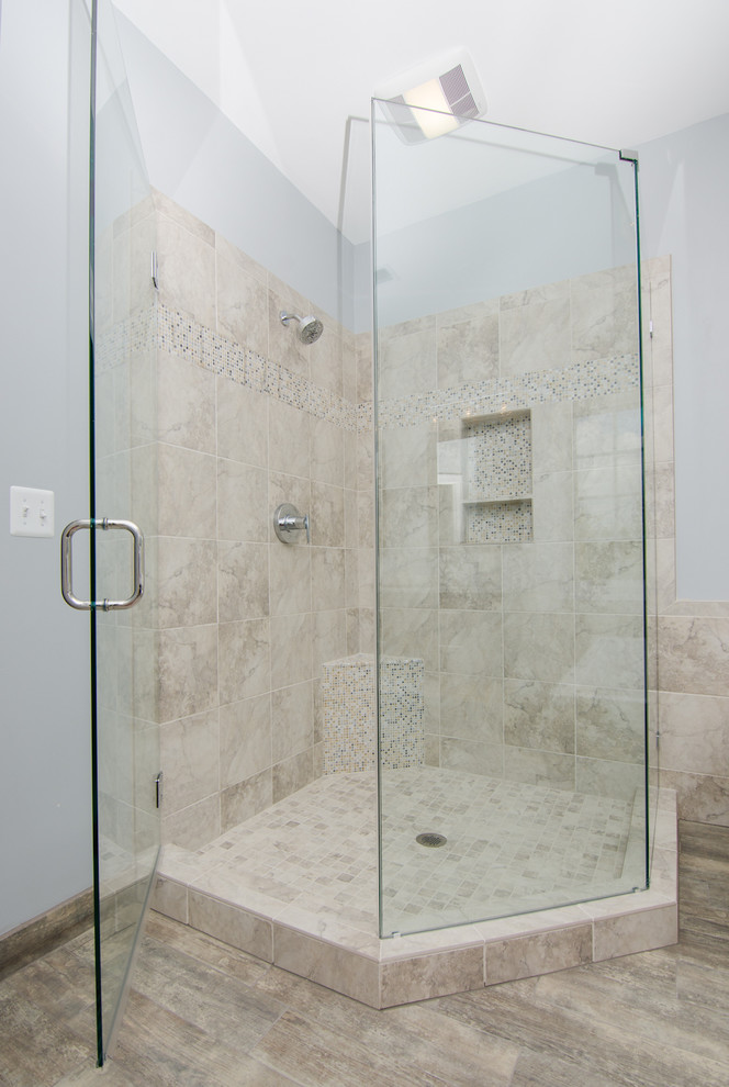 Inspiration for a mid-sized transitional master bathroom in DC Metro with an undermount sink, shaker cabinets, dark wood cabinets, granite benchtops, a freestanding tub, a corner shower, a two-piece toilet, beige tile, ceramic tile, blue walls, porcelain floors, brown floor and a hinged shower door.