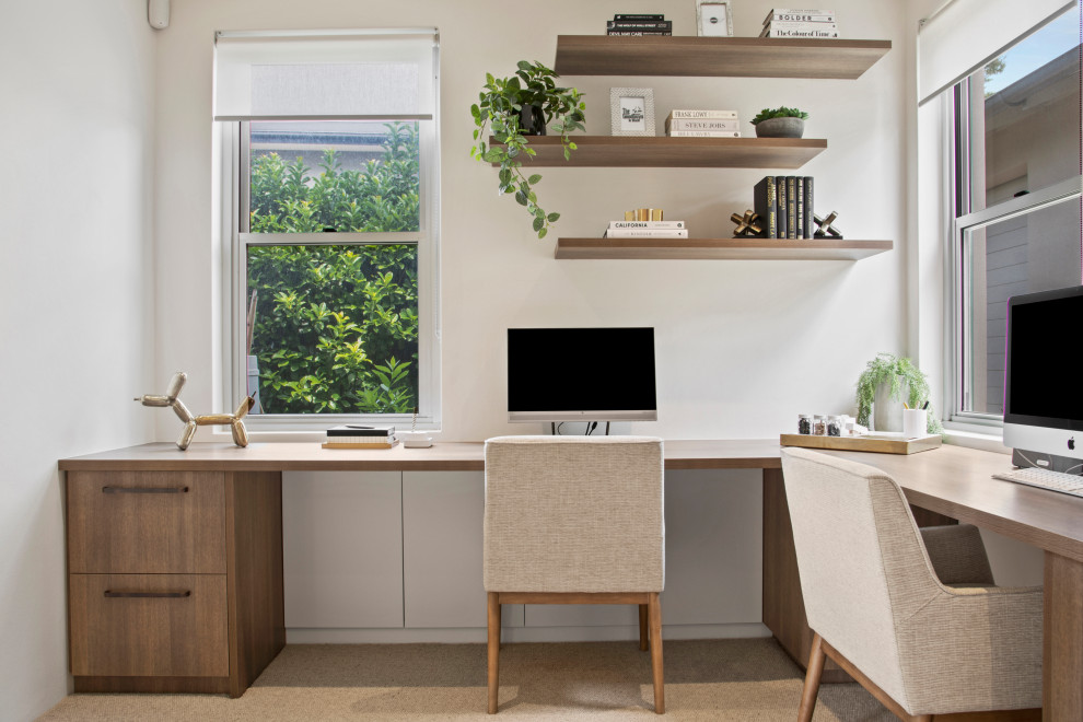 Inspiration for a beach style home office in Sydney with white walls, a built-in desk and grey floor.