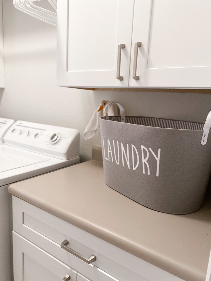 This is an example of a small modern galley laundry room in Phoenix with shaker cabinets, white cabinets, laminate benchtops and beige benchtop.
