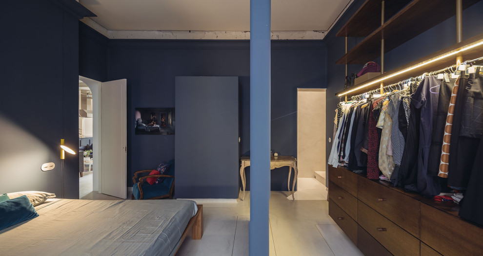 Design ideas for a contemporary master bedroom in Madrid with blue walls, concrete floors and beige floor.