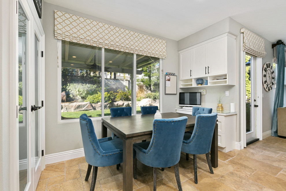 Huge transitional u-shaped travertine floor and beige floor open concept kitchen photo in Orange County with a single-bowl sink, shaker cabinets, white cabinets, quartz countertops, multicolored backsplash, stone tile backsplash, stainless steel appliances, an island and white countertops