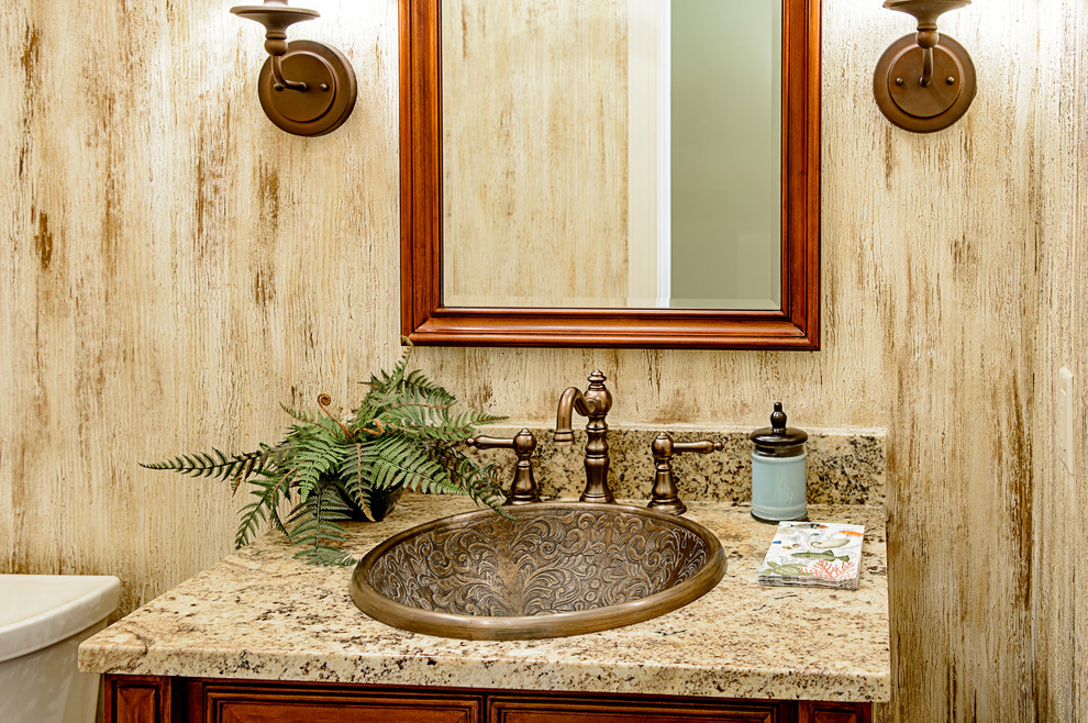 Inspiration for a small transitional powder room in Charleston with beige tile and granite benchtops.
