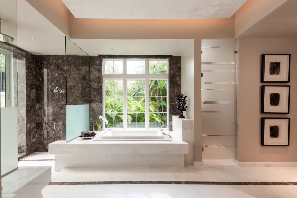 Photo of a large contemporary master bathroom in Miami with a drop-in tub, an open shower, beige walls, marble floors and an open shower.