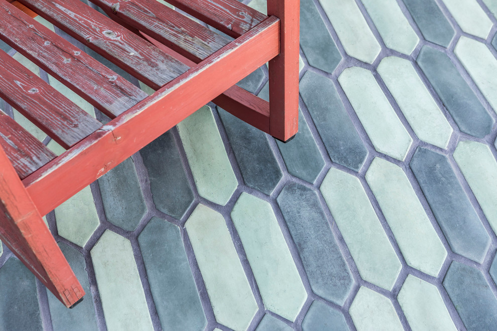 Inspiration for a mid-sized country backyard patio in Los Angeles with tile and an awning.