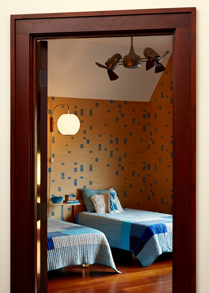 This is an example of a mid-sized midcentury kids' room for boys in New York with dark hardwood floors and multi-coloured walls.