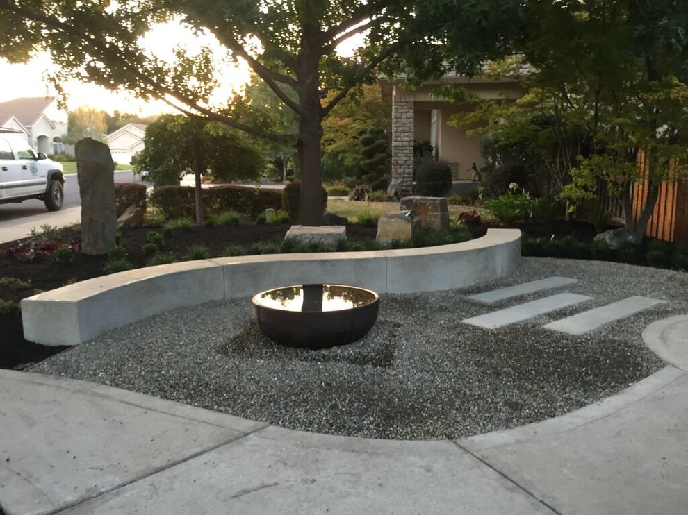Mid-sized contemporary front yard shaded xeriscape in Sacramento with a water feature and gravel.