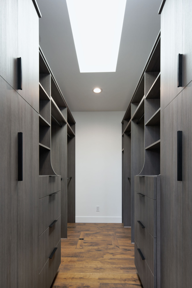 Photo of a large contemporary gender neutral walk-in wardrobe in San Francisco with flat-panel cabinets, brown cabinets, medium hardwood flooring and brown floors.