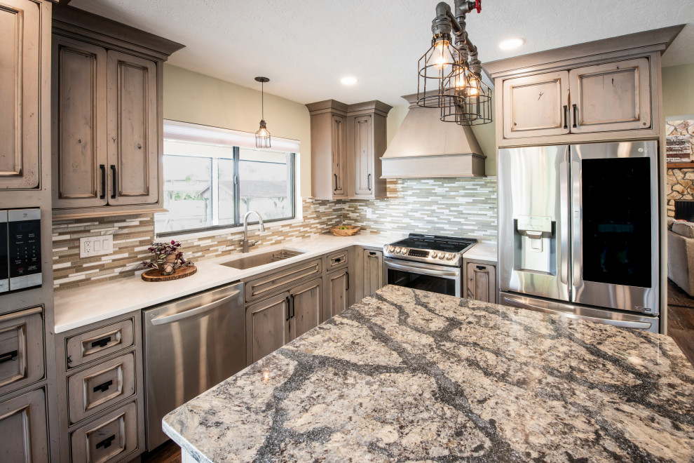 Large mountain style l-shaped brown floor eat-in kitchen photo in Orlando with an undermount sink, recessed-panel cabinets, distressed cabinets, quartz countertops, multicolored backsplash, mosaic tile backsplash, stainless steel appliances, an island and white countertops