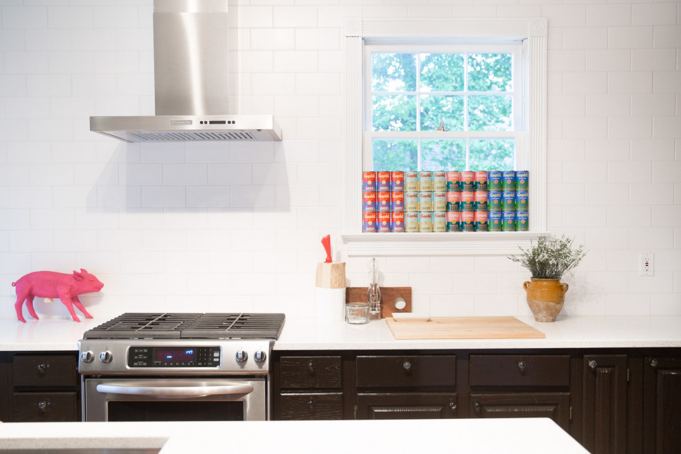 Enclosed kitchen - mid-sized transitional l-shaped medium tone wood floor enclosed kitchen idea with an undermount sink, raised-panel cabinets, dark wood cabinets, quartz countertops, white backsplash, ceramic backsplash, stainless steel appliances and an island