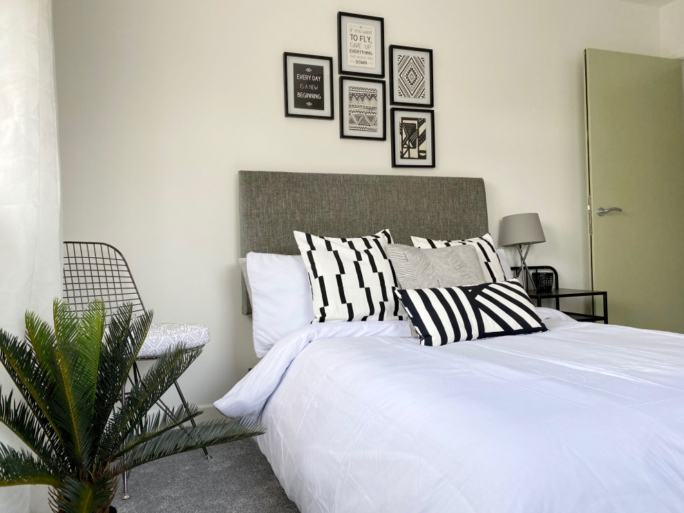 Inspiration for a small contemporary master bedroom in Gloucestershire with white walls, carpet and grey floor.