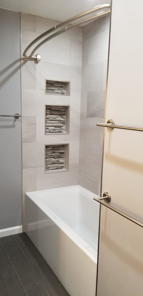 Inspiration for a mid-sized modern master bathroom in San Francisco with shaker cabinets, grey cabinets, an alcove tub, a shower/bathtub combo, gray tile, porcelain tile, grey walls, an undermount sink, engineered quartz benchtops, brown floor, a shower curtain and white benchtops.