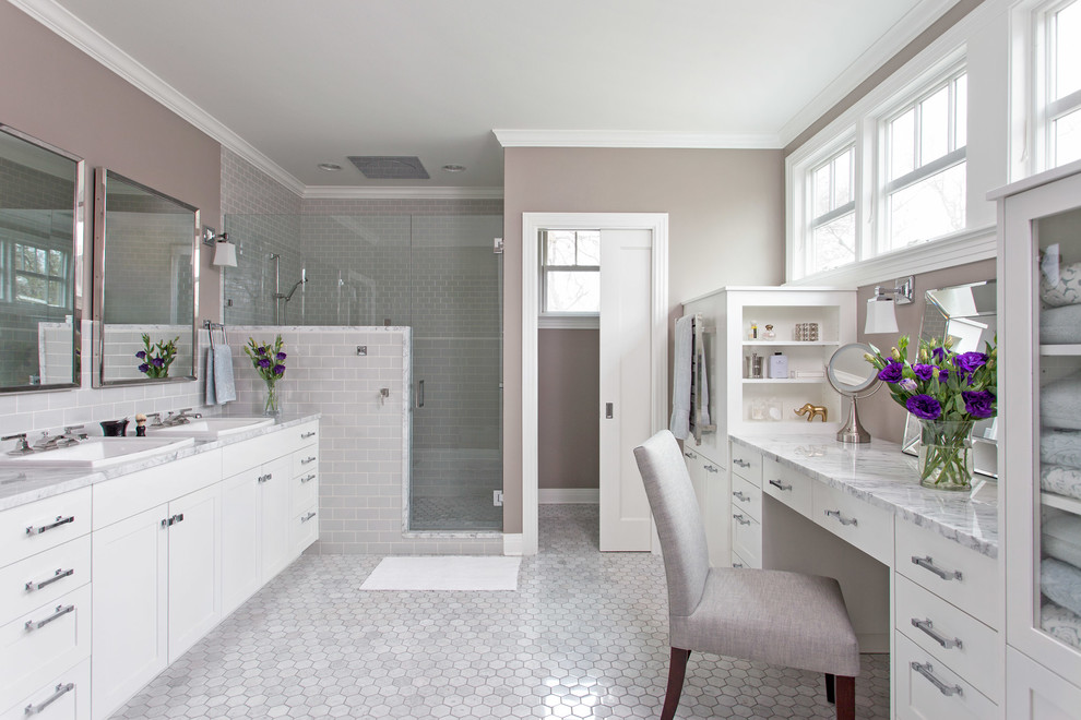 Photo of a mid-sized traditional master bathroom in Austin with shaker cabinets, white cabinets, a corner shower, subway tile, grey walls, marble benchtops, gray tile and marble floors.