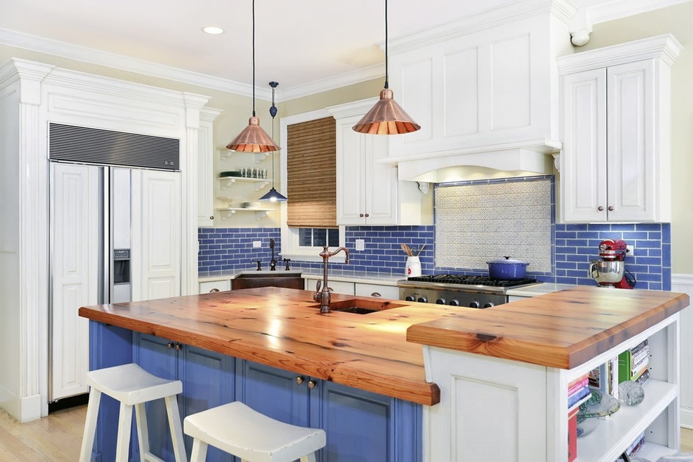 Photo of a traditional l-shaped kitchen in Other with an undermount sink, open cabinets, white cabinets, wood benchtops, blue splashback, subway tile splashback and panelled appliances.