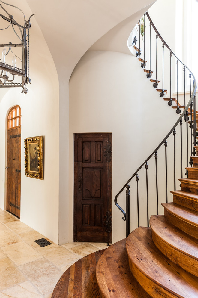 This is an example of a mediterranean wood staircase in Dallas with wood risers.