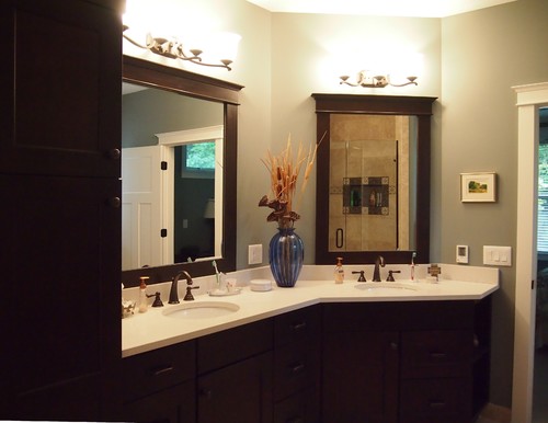 In smaller bathrooms, an L-shaped vanity can extend the space just enough to have space for a second sink.