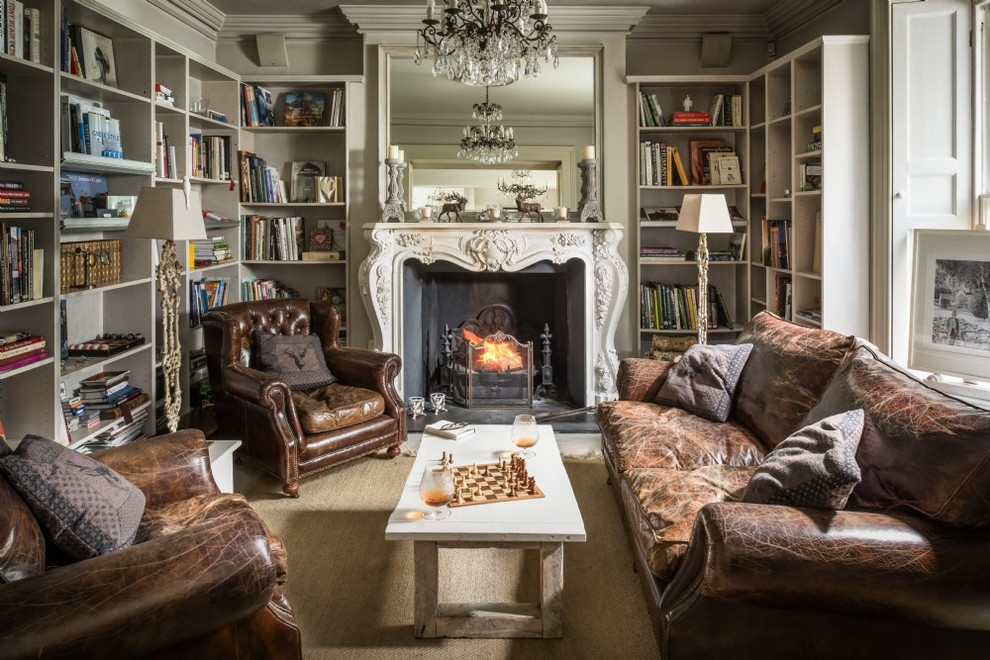 Mid-sized traditional enclosed living room in Other with a library, beige walls, carpet, a standard fireplace, a stone fireplace surround and beige floor.