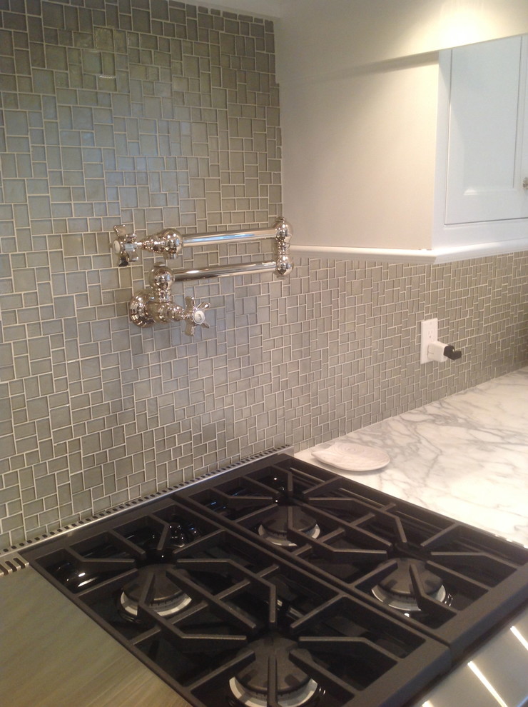 Transitional kitchen photo in New York with gray backsplash, glass sheet backsplash and stainless steel appliances