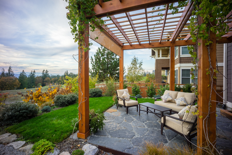 Traditional backyard patio in Seattle with a pergola.