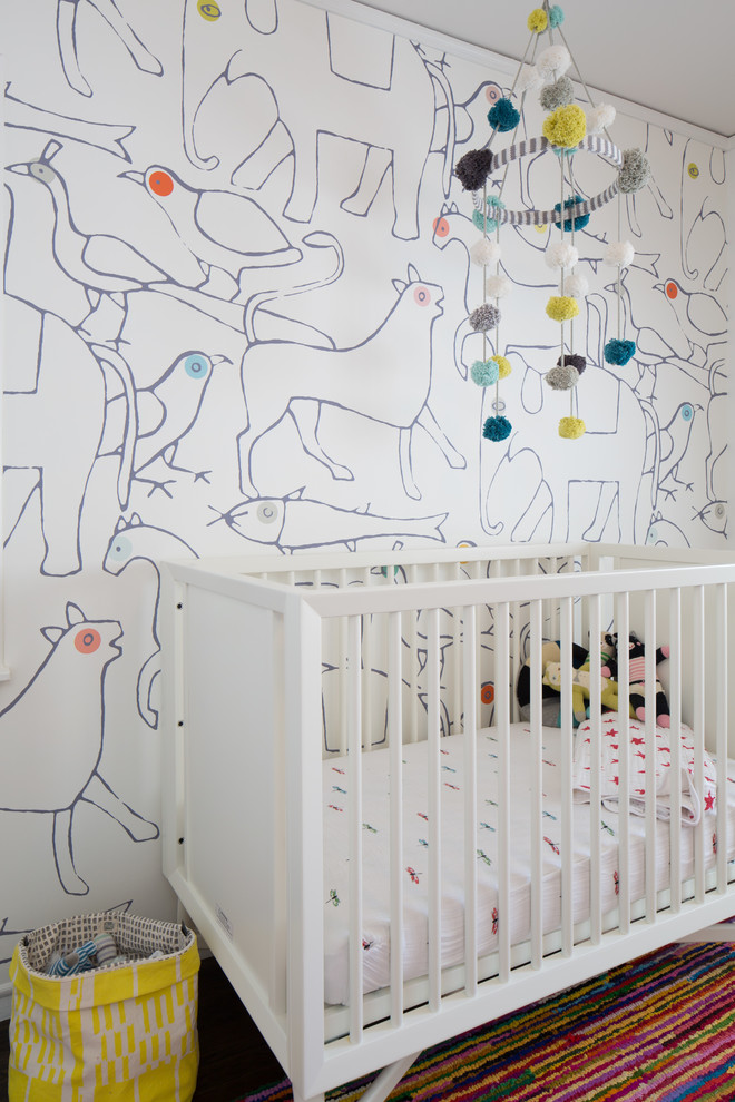 This is an example of a contemporary gender-neutral nursery in San Francisco with white walls.