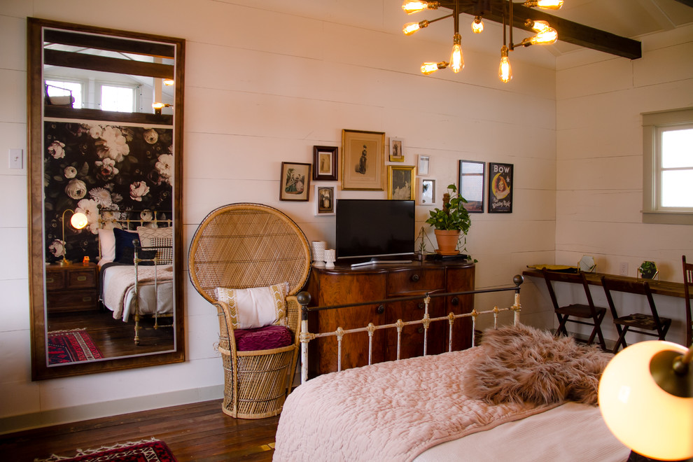 Inspiration for a large country master bedroom in Austin with white walls, dark hardwood floors and brown floor.