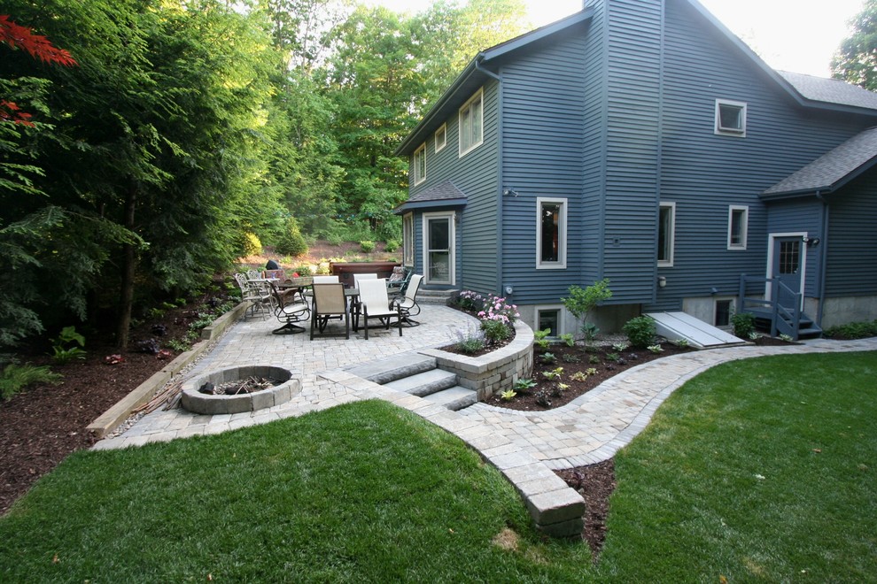 This is an example of a mid-sized modern backyard shaded outdoor sport court in Boston with concrete pavers.