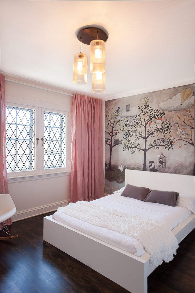 This is an example of a mid-sized transitional kids' bedroom for girls and kids 4-10 years old in Ottawa with multi-coloured walls, dark hardwood floors and brown floor.