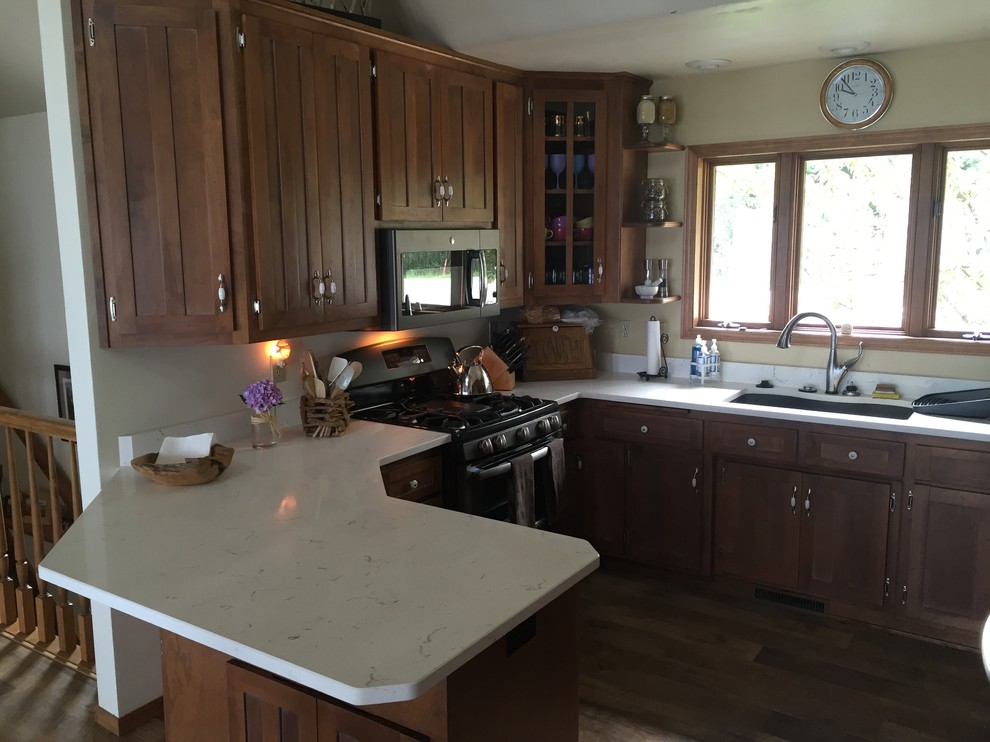 Kitchen - transitional vinyl floor kitchen idea with an undermount sink, medium tone wood cabinets, quartz countertops and white backsplash