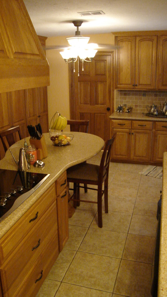 Mid-sized transitional l-shaped ceramic tile eat-in kitchen photo in Houston with a double-bowl sink, raised-panel cabinets, light wood cabinets, solid surface countertops, multicolored backsplash, subway tile backsplash, stainless steel appliances and an island