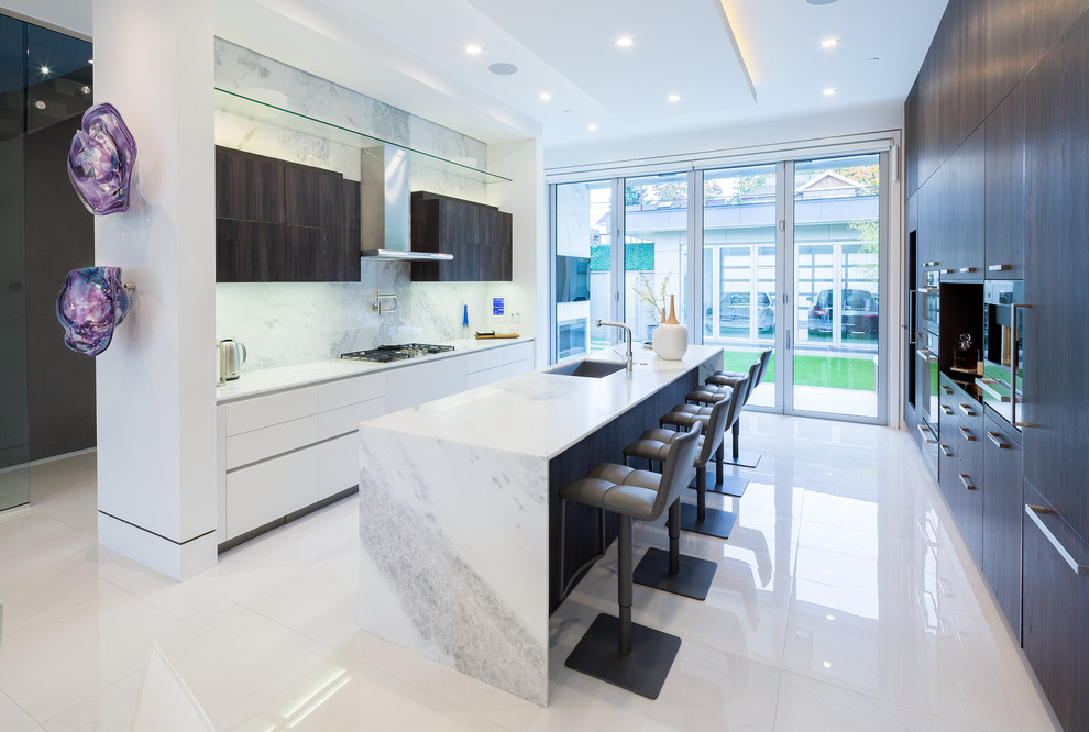 Photo of a large modern single-wall eat-in kitchen in Vancouver with an undermount sink, flat-panel cabinets, quartz benchtops, with island, dark wood cabinets, panelled appliances, marble floors and white floor.