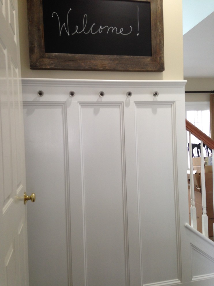 Inspiration for a small transitional mudroom in Boston with beige walls.