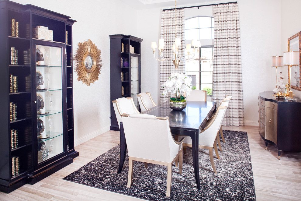 Photo of a transitional dining room in Las Vegas with light hardwood floors.