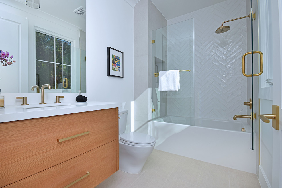 Photo of a large country master wet room bathroom in Los Angeles with flat-panel cabinets, white cabinets, a freestanding tub, a two-piece toilet, white tile, marble, white walls, light hardwood floors, a drop-in sink, engineered quartz benchtops, white floor, a hinged shower door and white benchtops.