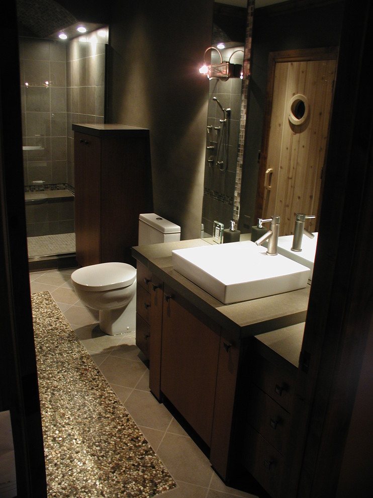 Large traditional master bathroom in Detroit with a vessel sink, flat-panel cabinets, engineered quartz benchtops, an alcove shower, a two-piece toilet, brown tile, stone tile, dark wood cabinets, brown walls and porcelain floors.