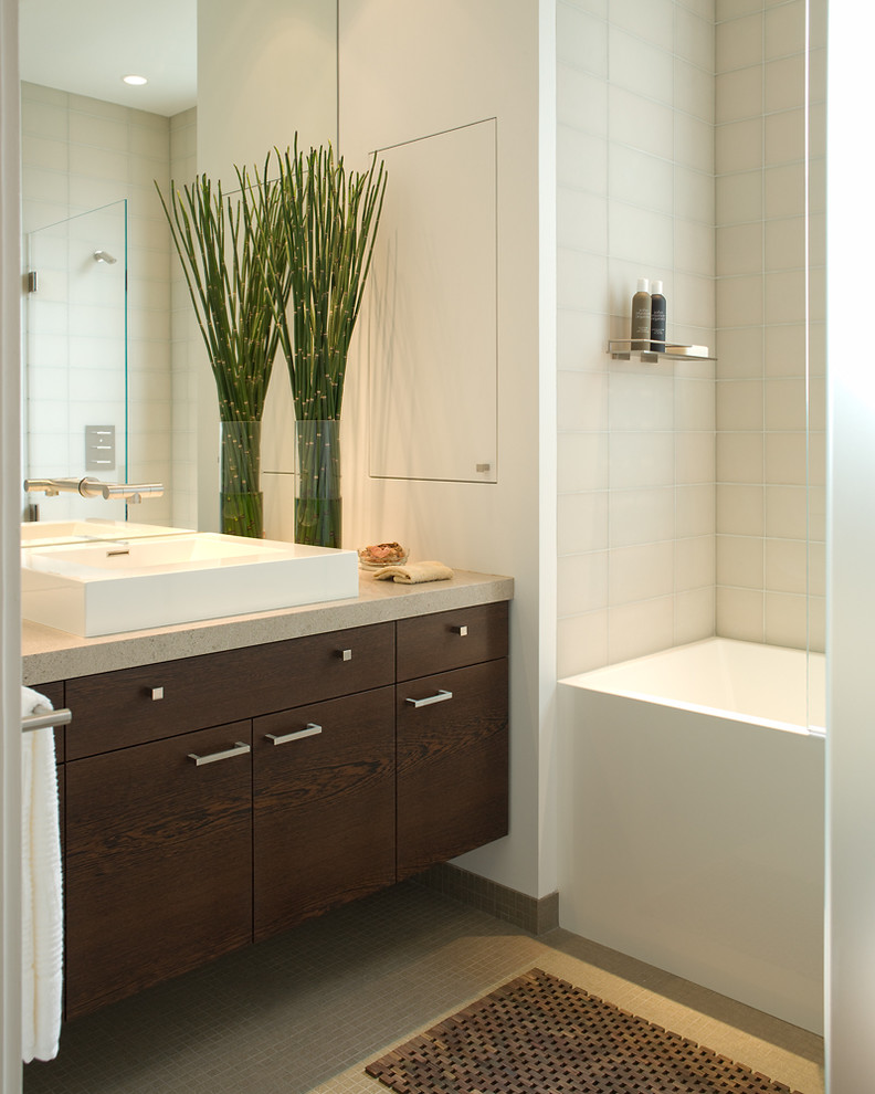 This is an example of a mid-sized contemporary 3/4 bathroom in San Francisco with flat-panel cabinets, dark wood cabinets, an alcove tub, a corner shower, a vessel sink, white tile, porcelain tile, mosaic tile floors, engineered quartz benchtops, beige floor and a hinged shower door.