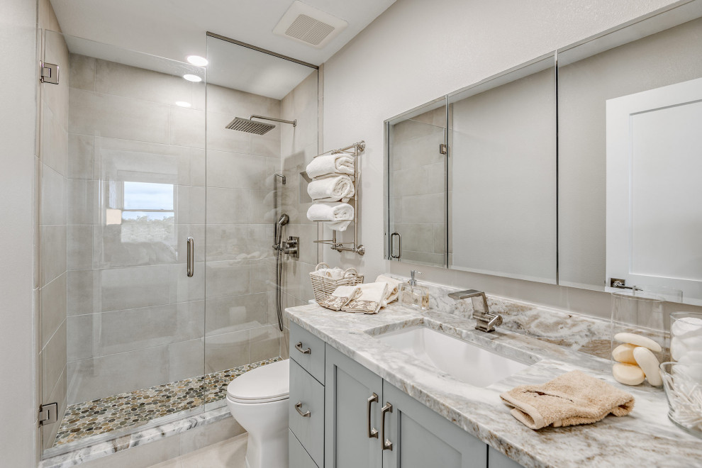 Small beach style master gray tile single-sink double shower photo in Tampa with gray cabinets, an undermount sink, granite countertops, a hinged shower door, gray countertops and a built-in vanity