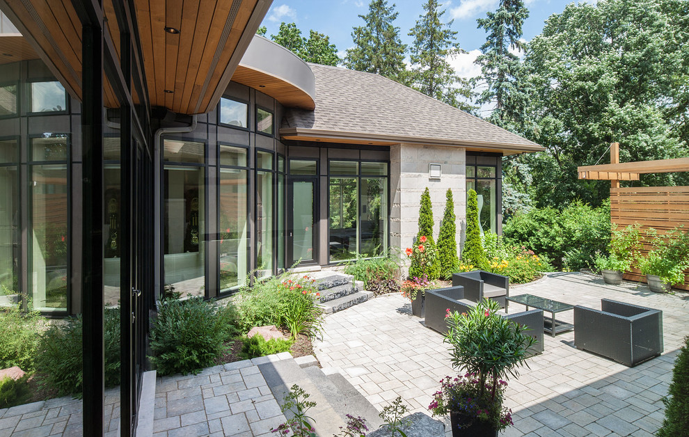 Contemporary patio in Ottawa with concrete pavers and no cover.
