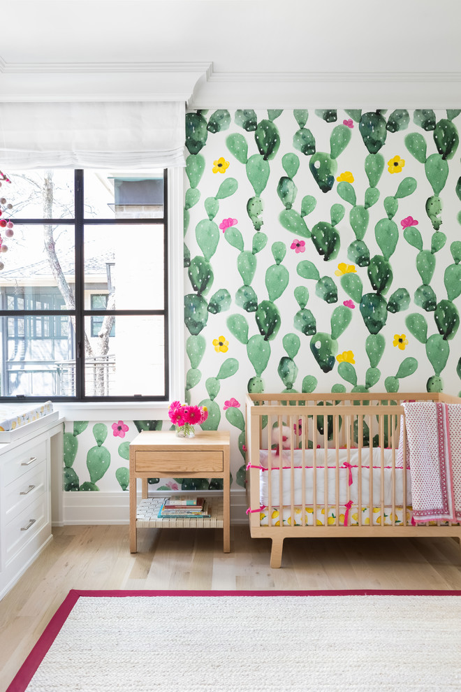 Inspiration for a large transitional nursery for girls in Austin with light hardwood floors and brown floor.