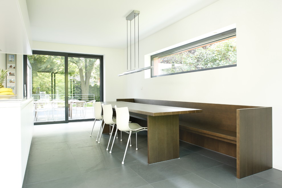 This is an example of a mid-sized contemporary dining room in Cologne with white walls.