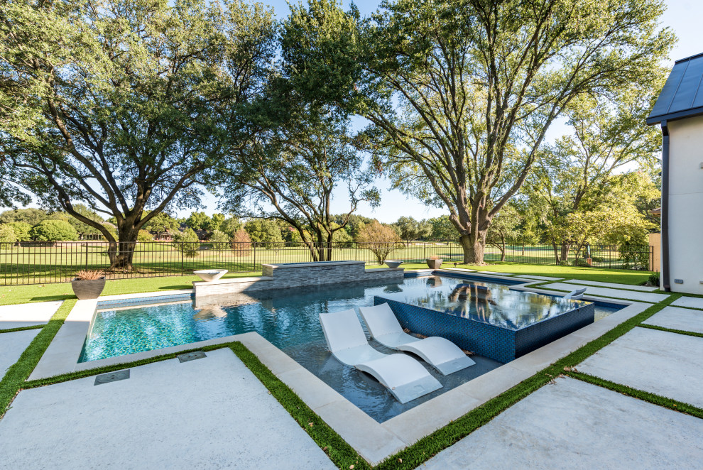 Inspiration for a mid-sized transitional backyard rectangular natural pool in Dallas with a hot tub and concrete pavers.