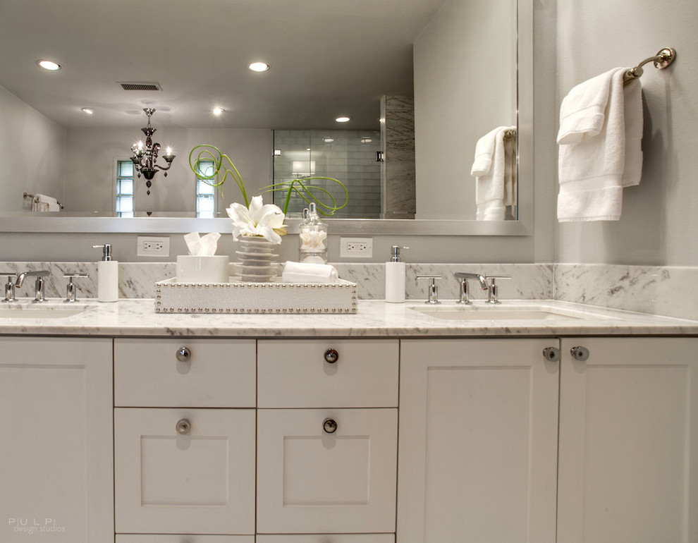 Inspiration for a large transitional master bathroom in Dallas with an undermount sink, recessed-panel cabinets, white cabinets, marble benchtops, a drop-in tub, an open shower, a one-piece toilet, white tile, glass tile, grey walls and marble floors.