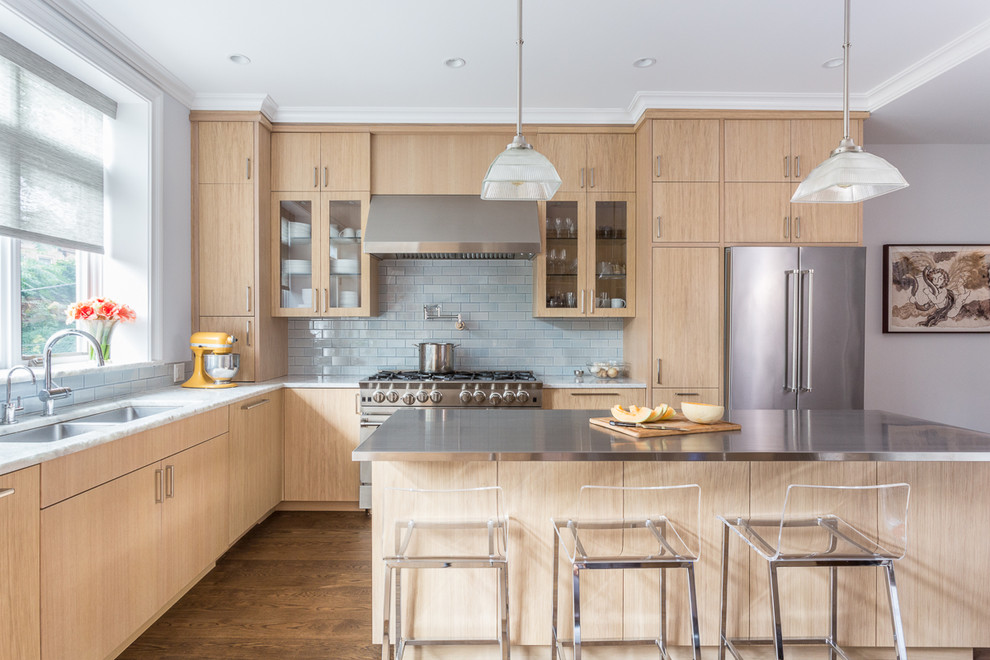Mid-sized contemporary l-shaped kitchen in New York with flat-panel cabinets, light wood cabinets, quartzite benchtops, blue splashback, ceramic splashback, stainless steel appliances, medium hardwood floors, with island and a double-bowl sink.