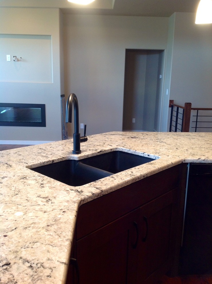 Inspiration for a l-shaped kitchen remodel with an undermount sink, an island and granite countertops