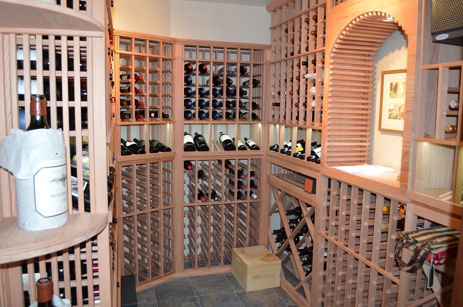 Photo of a small wine cellar in Orange County with storage racks.
