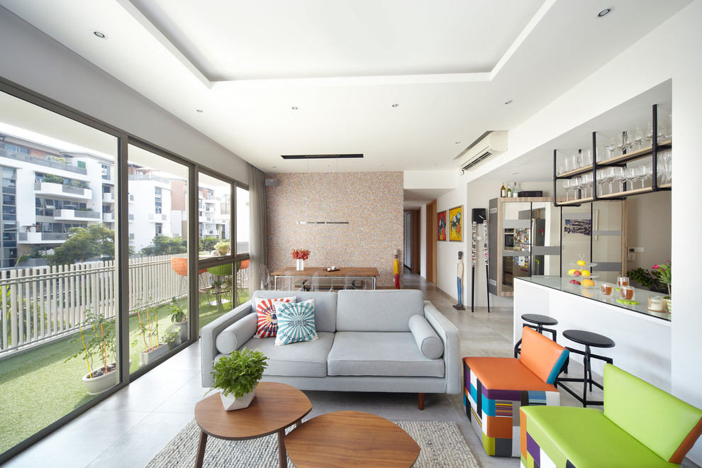 This is an example of a contemporary open concept living room in Singapore with white walls.