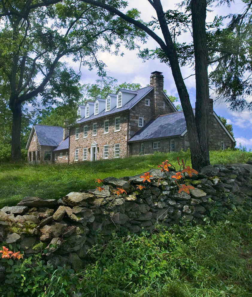 Mid-sized country beige three-story stone exterior home idea in DC Metro with a shingle roof