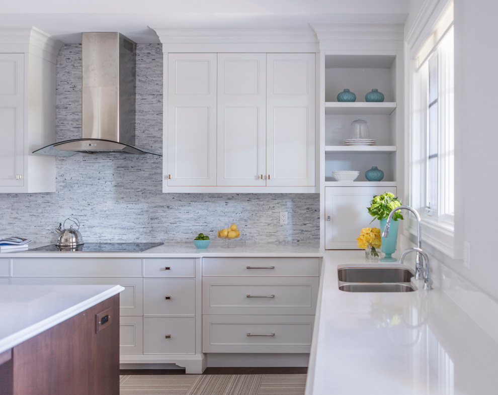 Eat-in kitchen - transitional u-shaped medium tone wood floor eat-in kitchen idea in Toronto with an undermount sink, recessed-panel cabinets, white cabinets, quartz countertops, white backsplash, stone tile backsplash, stainless steel appliances and an island