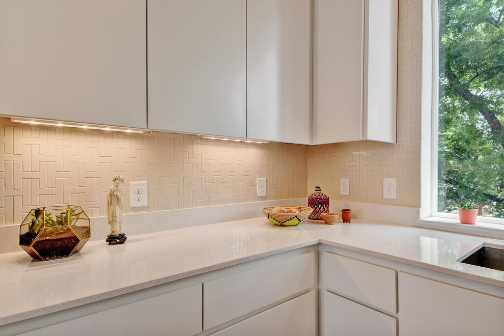 This is an example of a mid-sized modern eat-in kitchen in Other with a single-bowl sink, flat-panel cabinets, white cabinets, solid surface benchtops, pink splashback, ceramic splashback, stainless steel appliances, bamboo floors and with island.