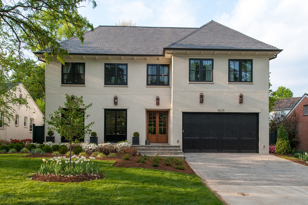 Large transitional three-storey stucco beige house exterior in DC Metro with a hip roof and a shingle roof.