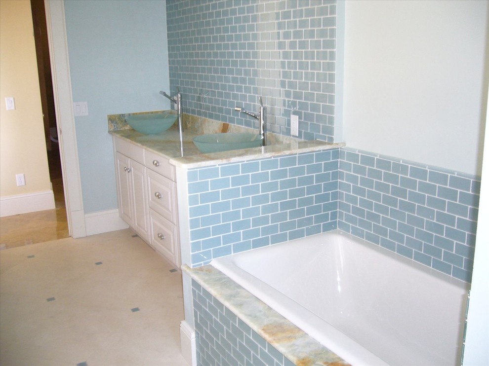 Inspiration for a large master beige tile and ceramic tile ceramic tile bathroom remodel in Orlando with flat-panel cabinets, white cabinets, granite countertops and beige walls
