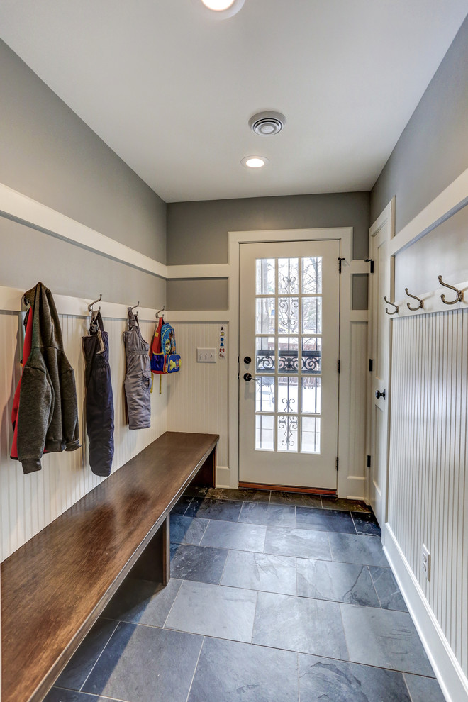 This is an example of a small traditional mudroom in Minneapolis with grey walls, slate floors, a single front door, a glass front door and grey floor.